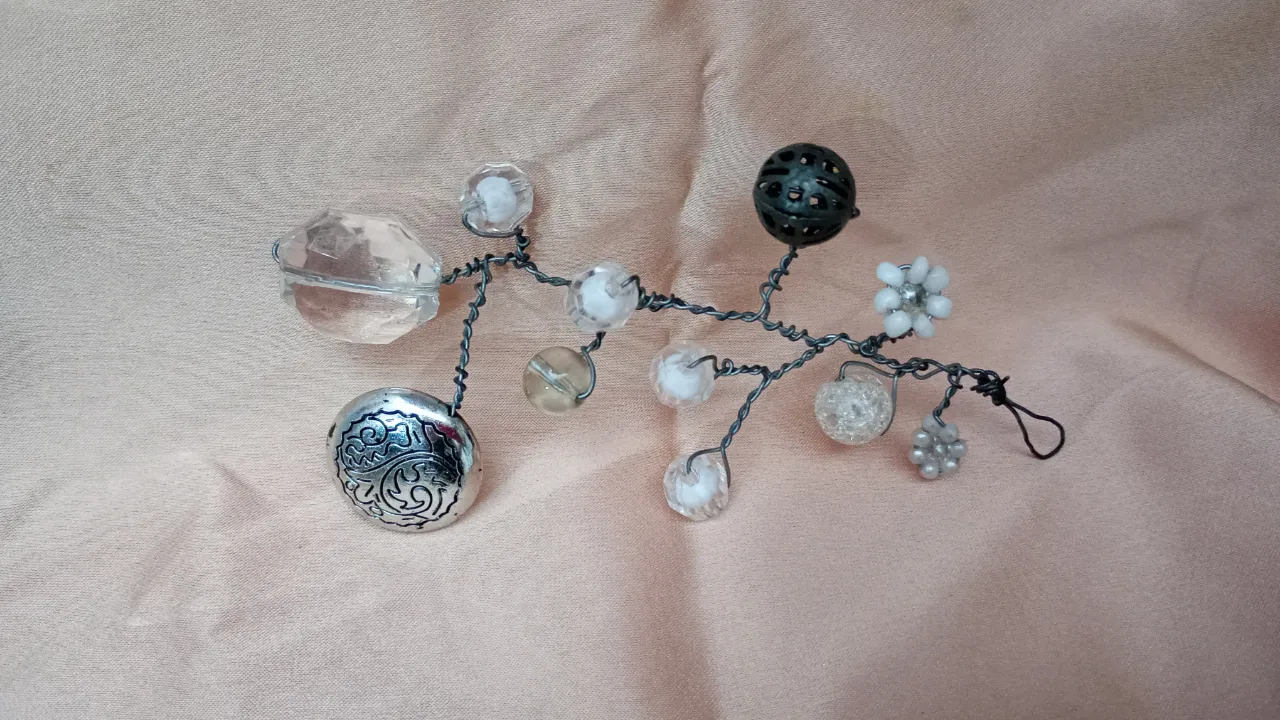 Adorno para el pelo artesanal con diseño floral y detalles de piedras y cuentas. Ideal para eventos especiales o para darle un toque único a tu look.
