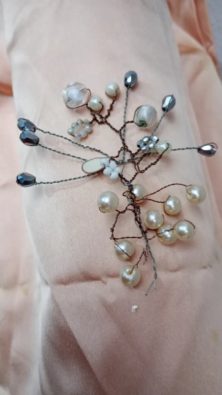 Adorno para el pelo con diseño de ramas y perlas. Ideal para peinados de fiesta o eventos especiales. Un accesorio elegante y delicado.