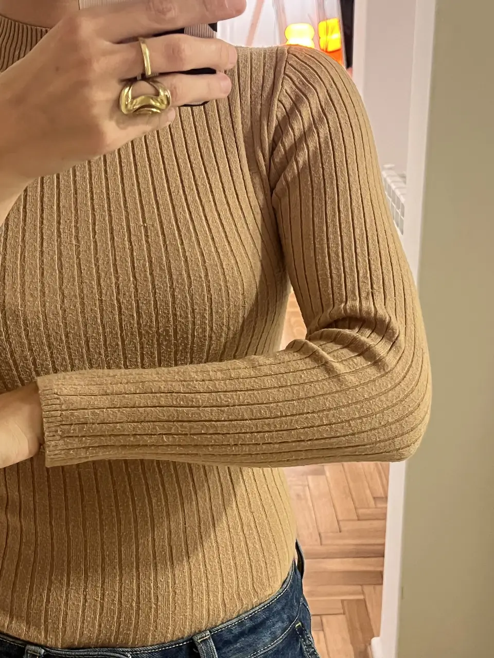 Sweater de cuello alto color beige, tejido acanalado. Ideal para un look casual y abrigado.