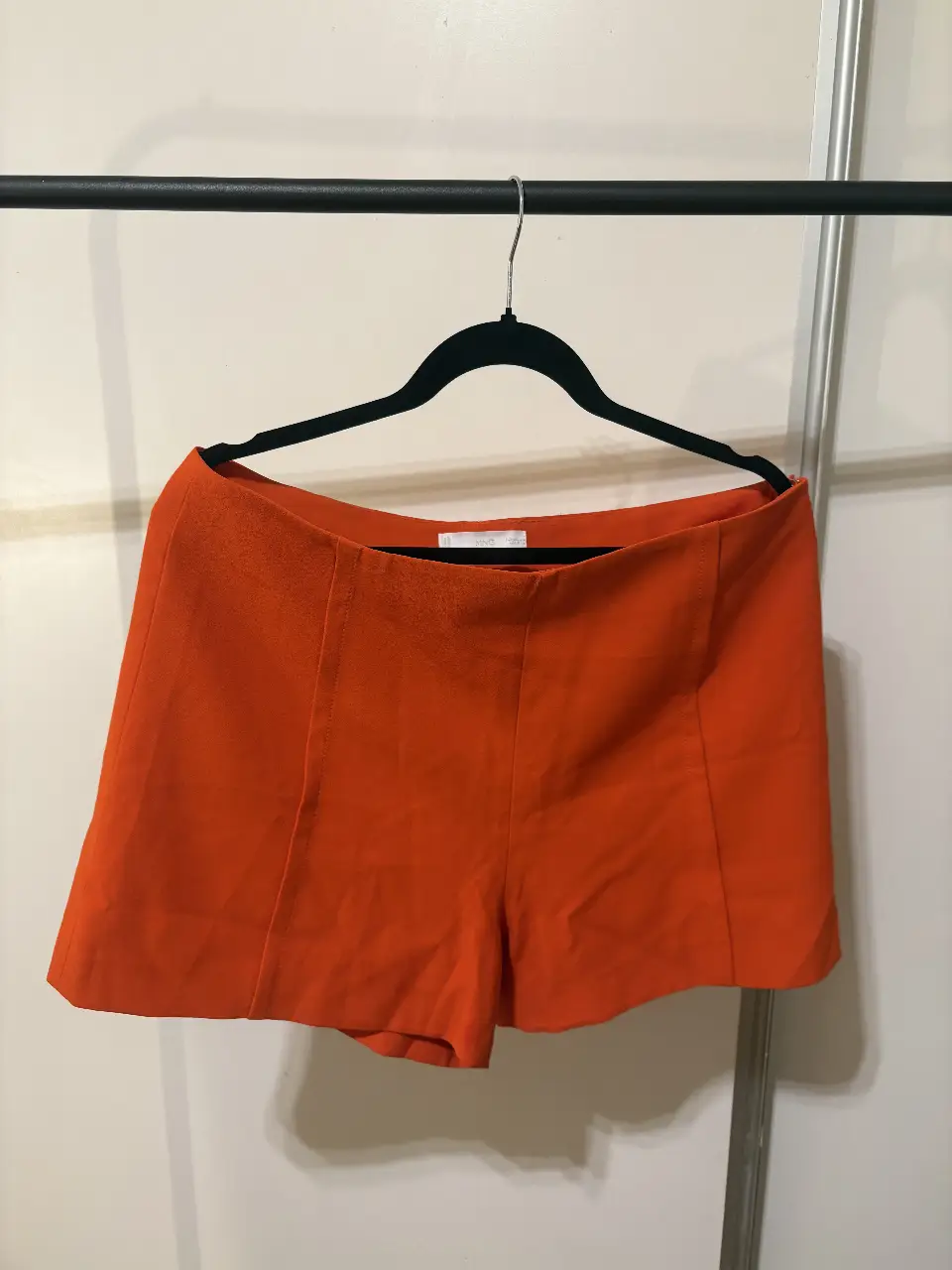 Short naranja tiro alto de tela, ideal para un look moderno y fresco. Perfecto para combinar con tops y blusas.