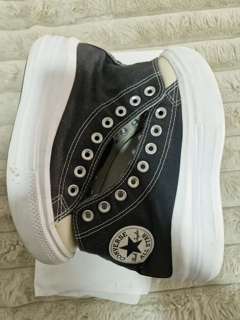 Zapatillas Converse All Star negras de caña alta con suela blanca. Un clásico atemporal para un look urbano y versátil.