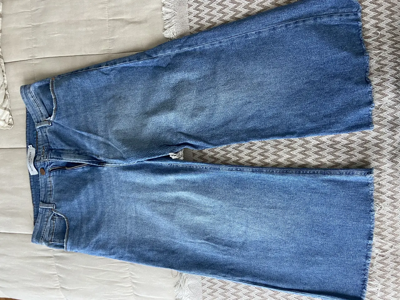 Jean de mujer Patricia Foster, modelo calza wide, talle 40. Corte recto con terminación desflecada. Tiro medio. Ideal para un look casual y cómodo. 