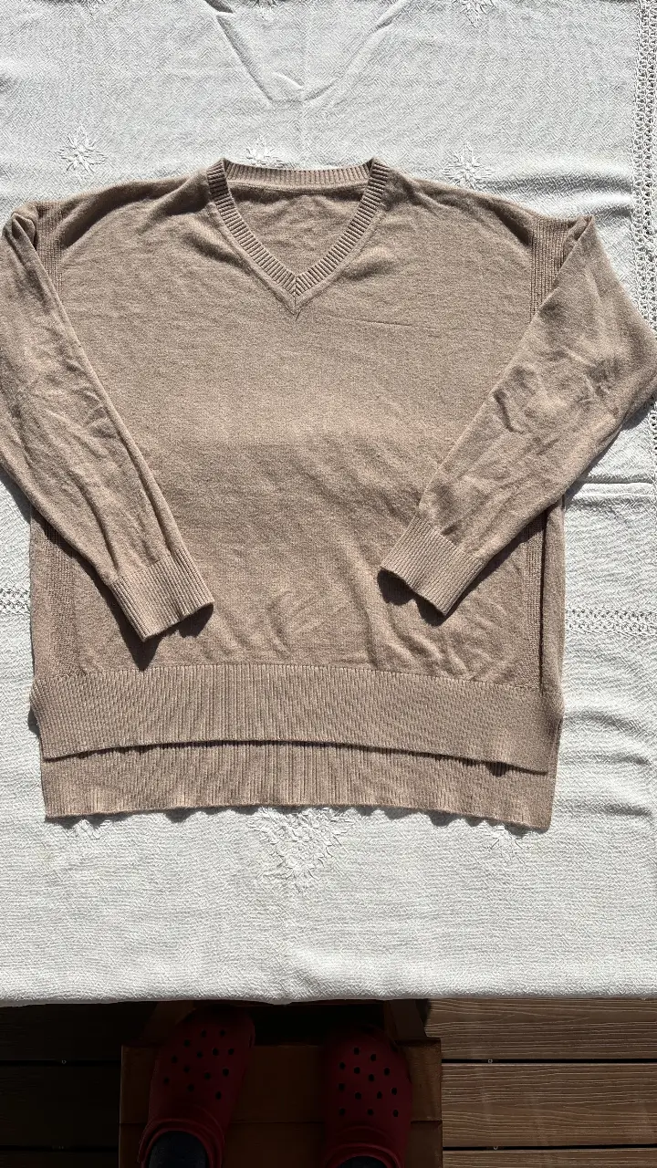 Sweater en color marrón claro, con cuello en V y mangas largas. Ideal para un look casual y cómodo.