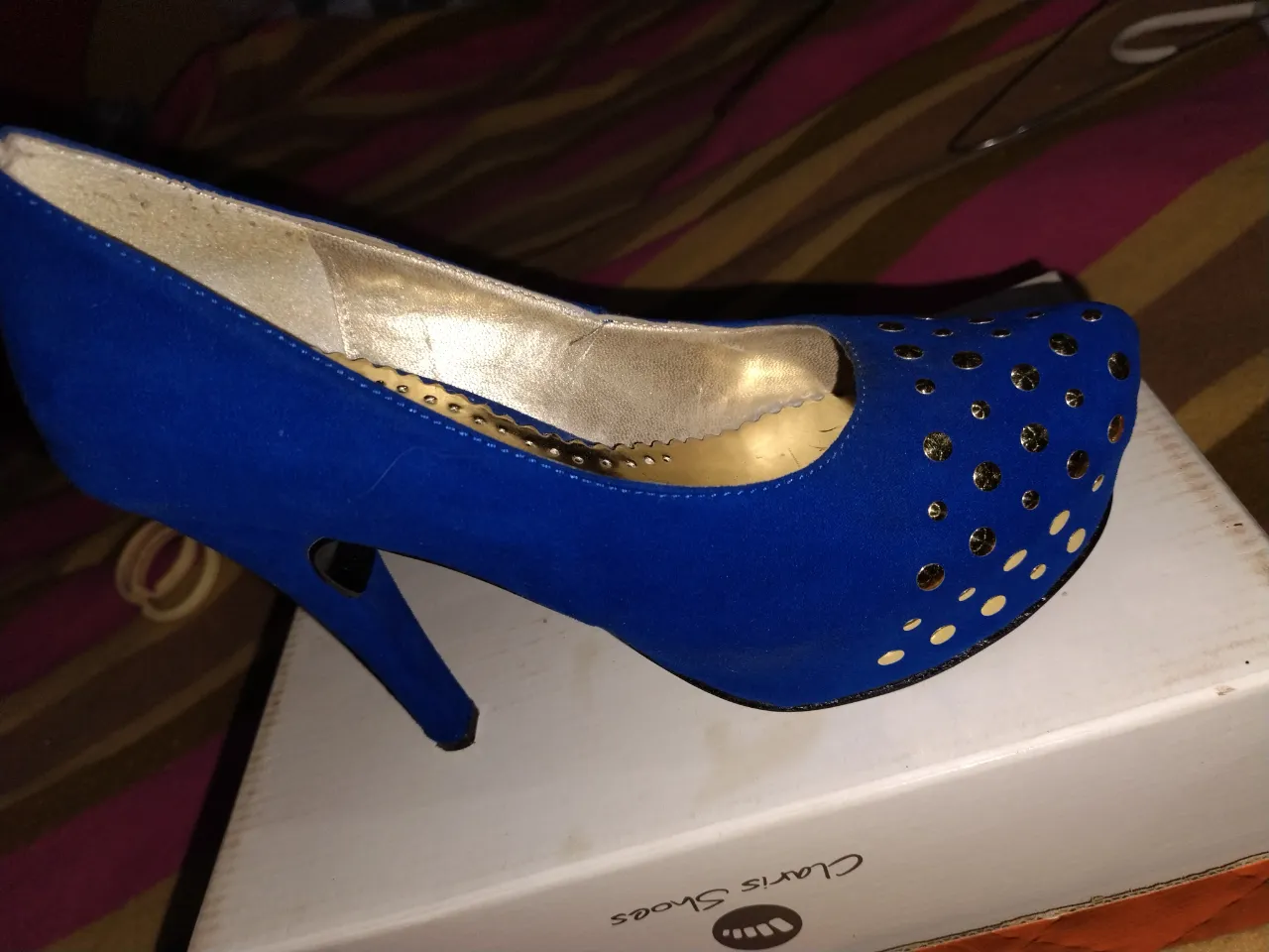 Zapatos de taco alto para mujer, color azul eléctrico con detalles dorados. Diseño elegante con apliques dorados en la puntera y un tacón fino. Ideales para fiestas y eventos especiales.