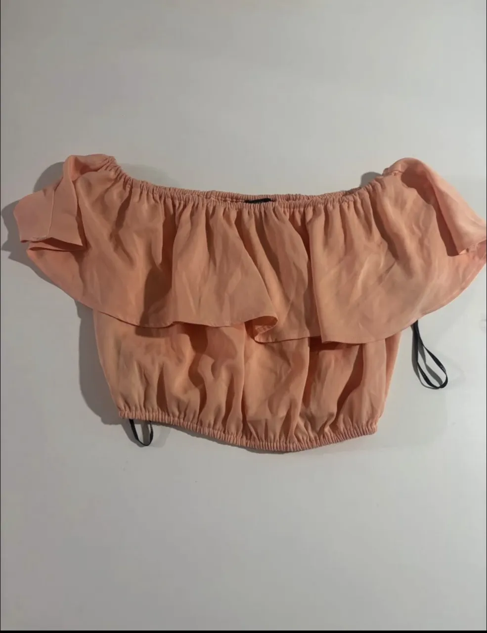 Top color salmón con volados y elástico en la cintura.