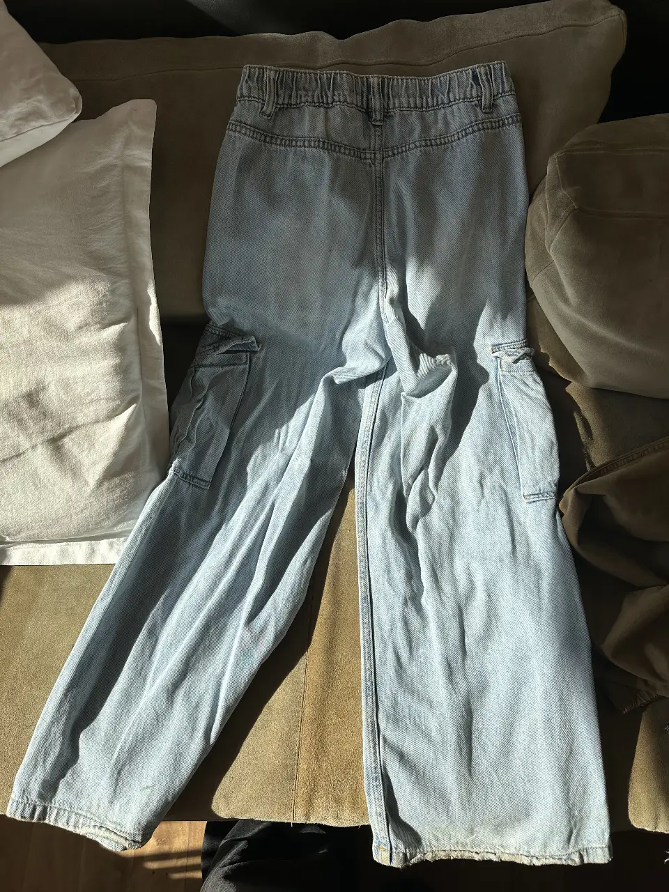 Pantalón cargo de jean azul claro, tiro alto y corte wide leg. Con bolsillos laterales amplios y cintura elastizada para mayor comodidad. Ideal para un look casual y moderno.