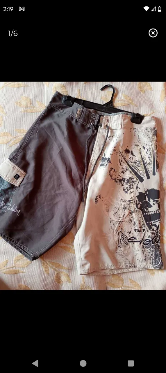 Shorts de baño de dos tonos, uno gris oscuro y otro blanco con estampa de calavera y letras. Posee un bolsillo cargo en el lateral izquierdo. Talle 40. En excelente estado sin detalles