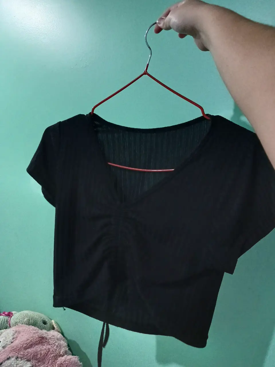 Top negro con fruncido en el centro y escote en V. Ideal para un look casual y moderno.