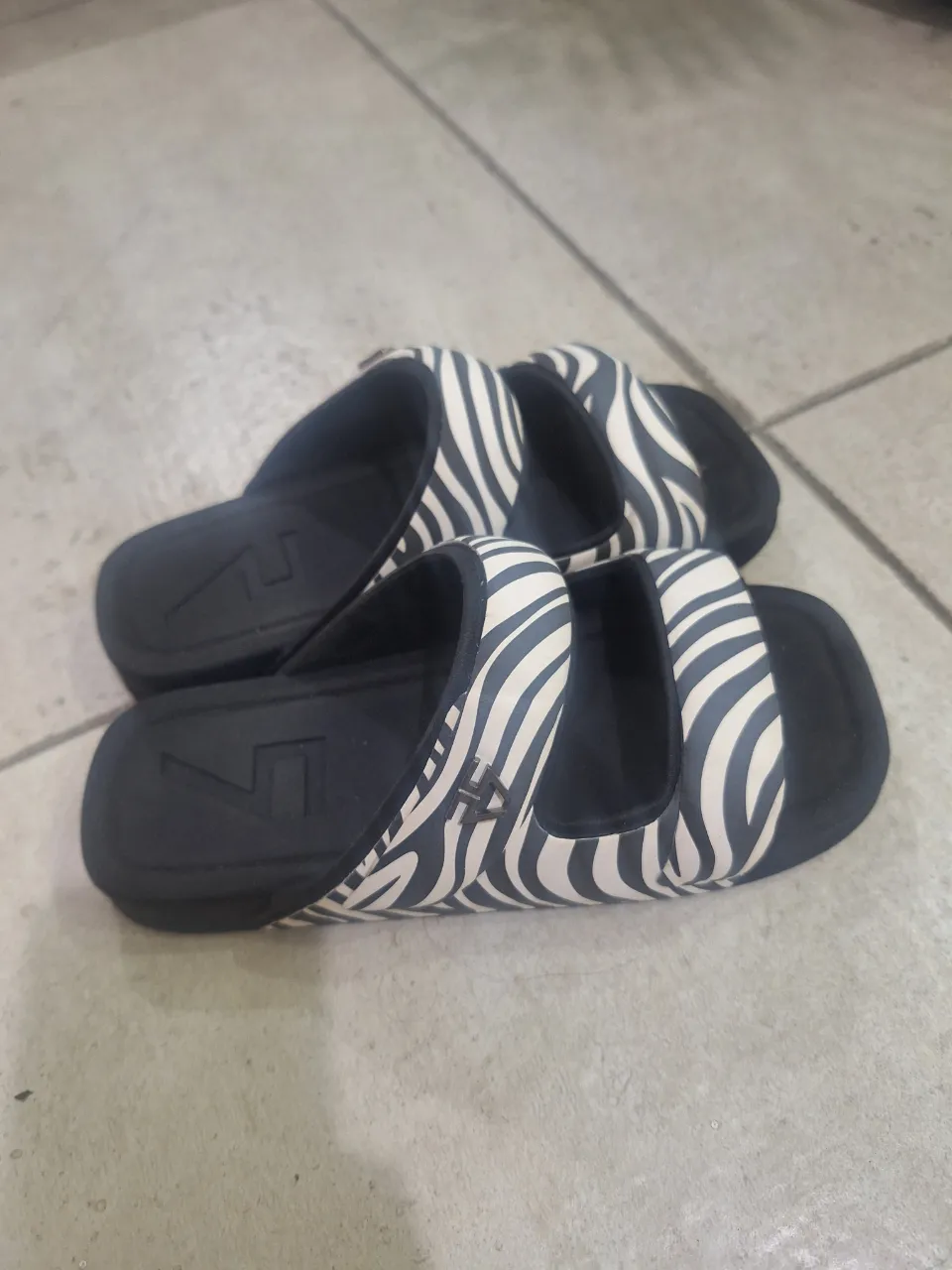 Sandalias súper cómodas con estampa de cebra en blanco y negro. Ideales para el día a día, para estar en casa o para la playa. ¡Un clásico que no pasa de moda!