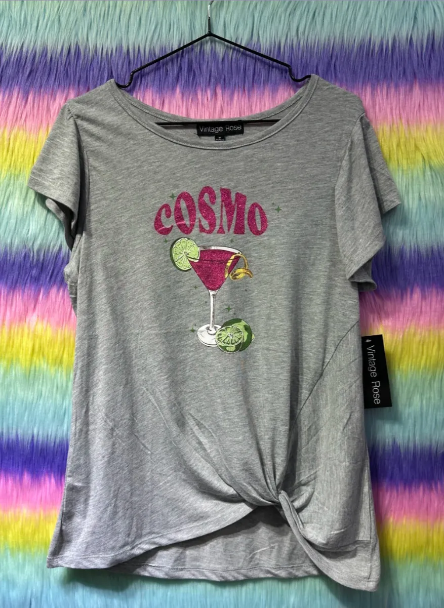 Remera gris de mujer con estampado "Cosmo" y diseño anudado en la cintura. Ideal para un look casual y moderno.