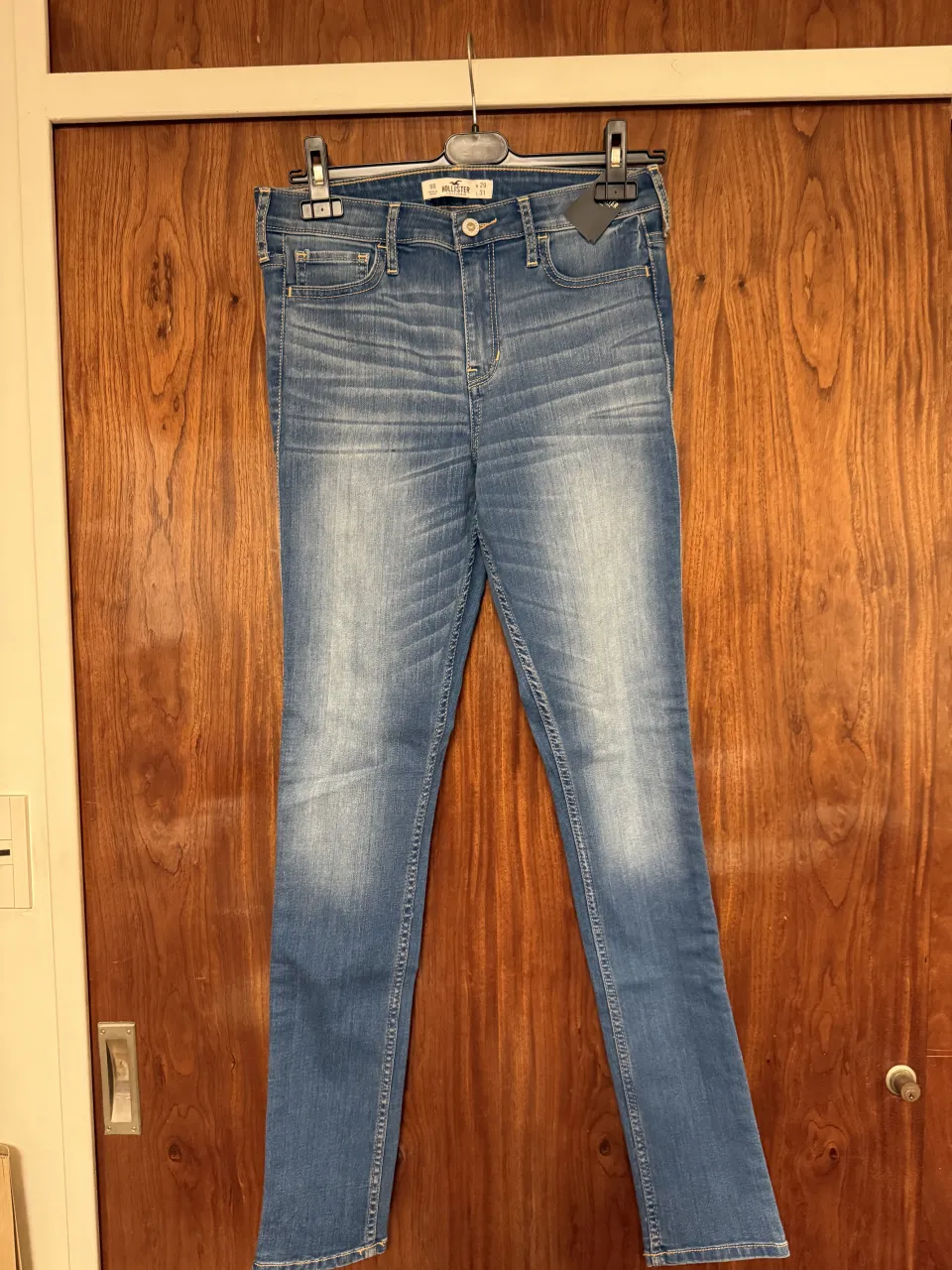 Jeans de tiro alto con lavado desgastado y costuras en los bolsillos traseros.