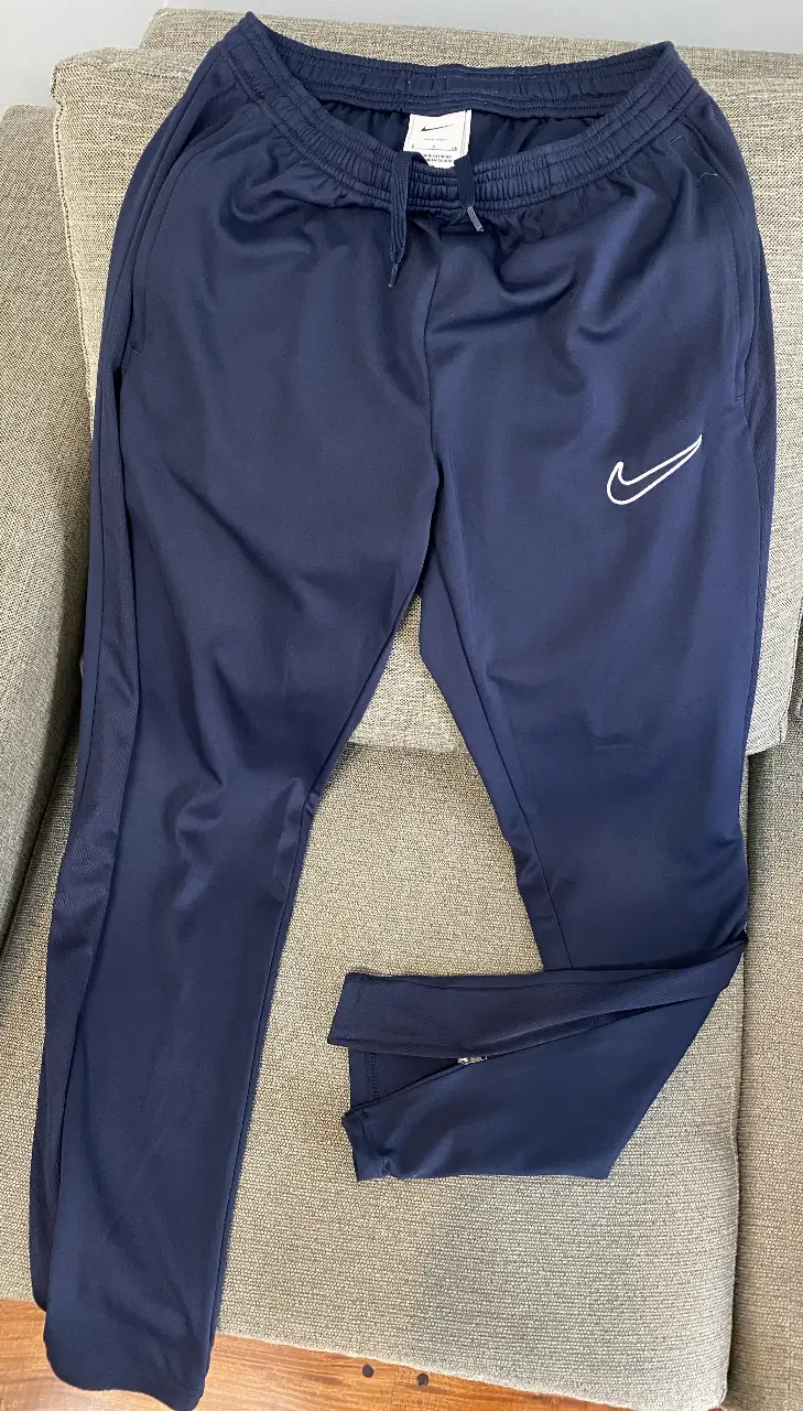 Pantalón deportivo de hombre, color azul marino, con el logo de Nike en blanco. Es original. Tiene bolsillos laterales y cierre en los tobillos. Ideal para actividades deportivas o uso casual.