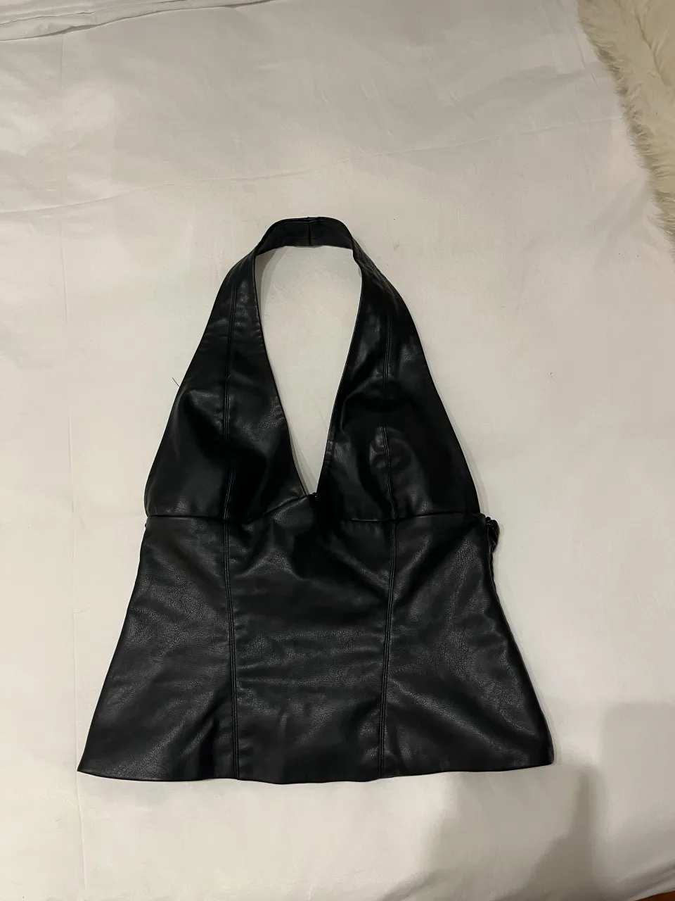 Top negro escotado con breteles al cuello.