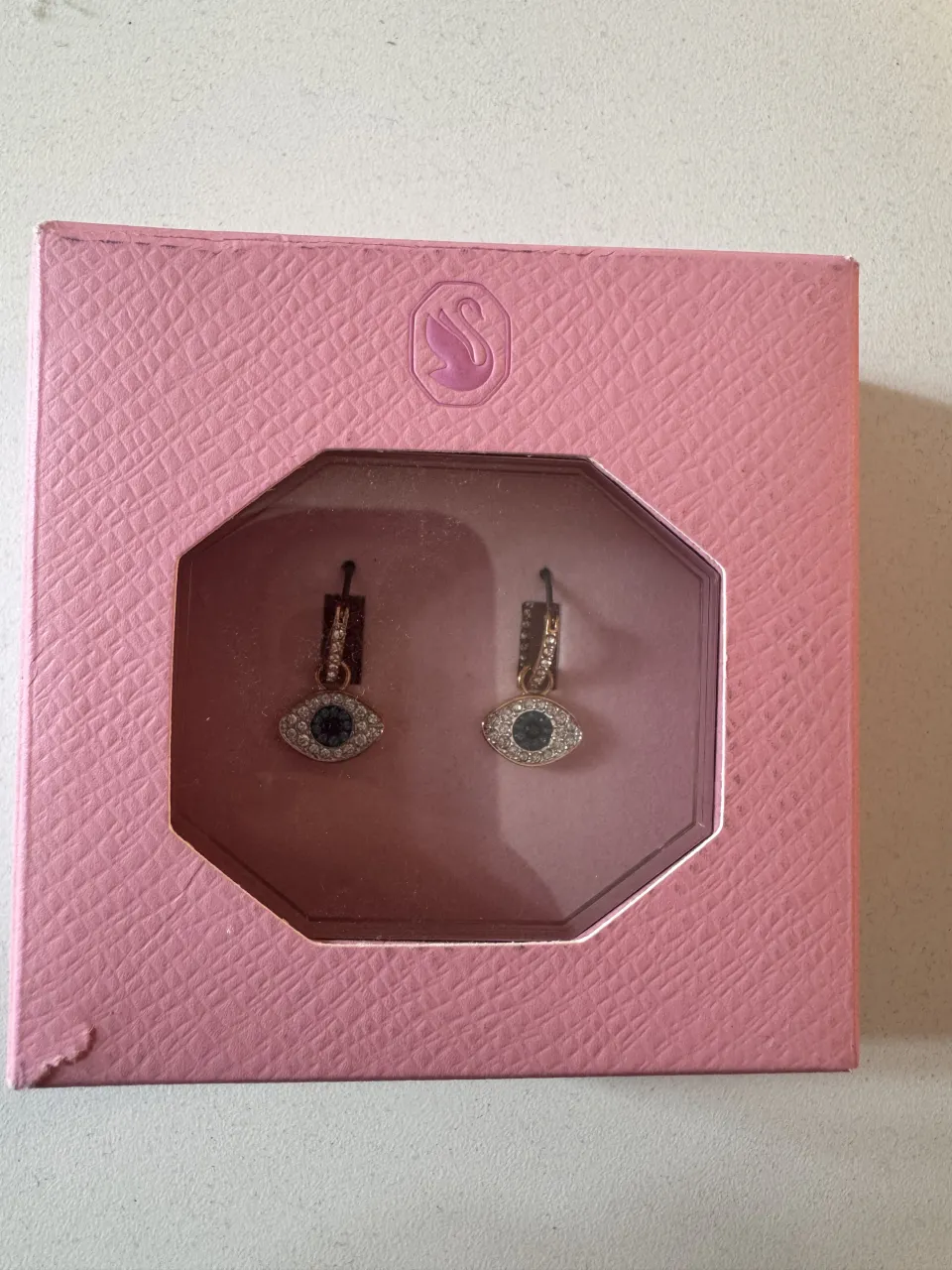 Aros de ojo turco con detalles en strass plateado y centro azul. Vienen en su caja original de Swarovski, (tienen un solo uso)