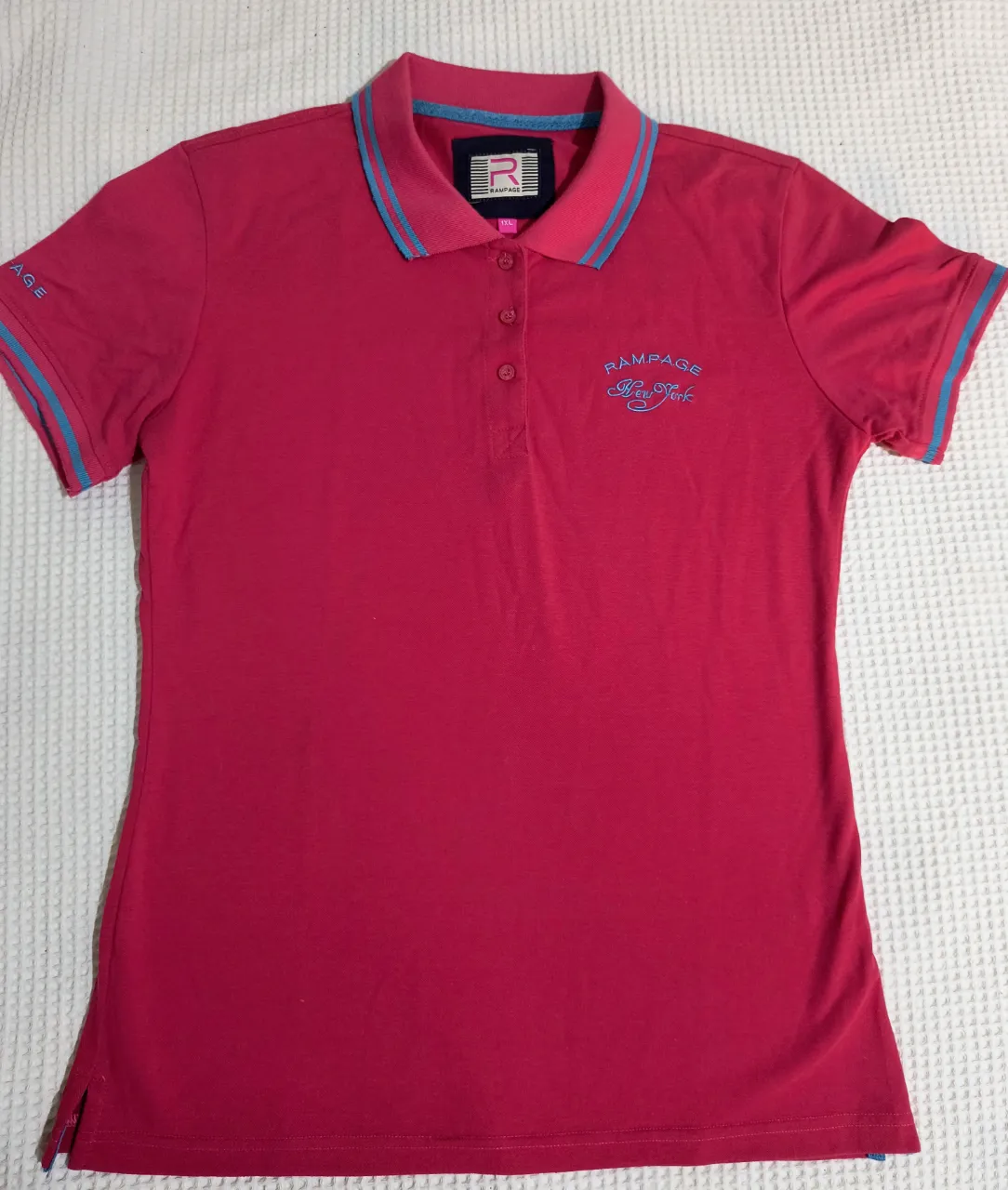 Chomba fucsia con detalles turquesas.