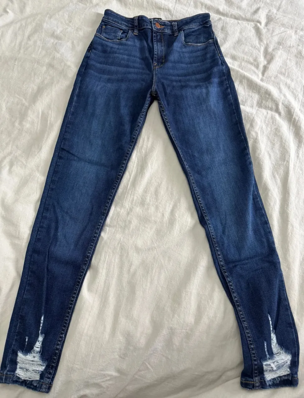 Jeans de tiro alto con roturas en los tobillos. Un clásico que no puede faltar en tu guardarropa, ideales para un look canchero y moderno. Combinan a la perfección con todo tipo de tops y calzado.
