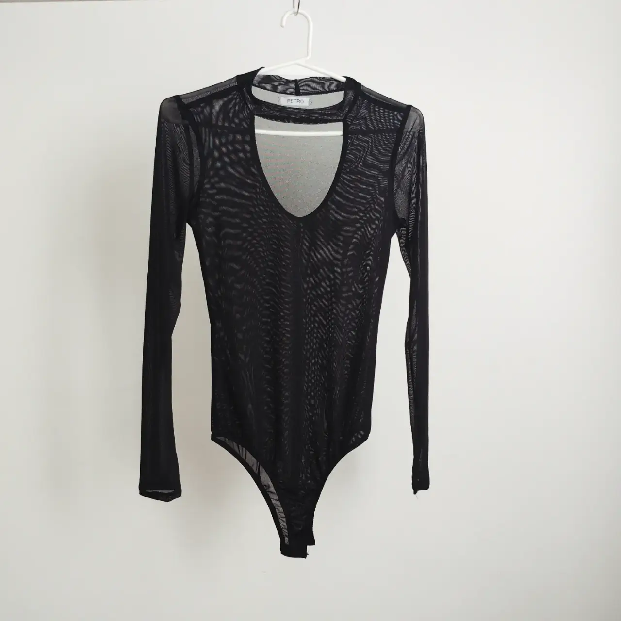 Body de micro tul negro con escote en V y mangas largas. Ideal para looks de fiesta o para darle un toque audaz a tu outfit. doble tul en la parte de adelante. 