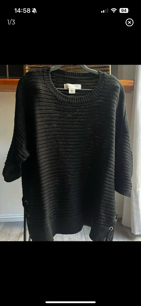 Sweater negro de tejido grueso con detalles de cordones en los laterales. Manga 3/4 y corte holgado, ideal para un look casual y cómodo. talle único. largo 65, ancho 61, sisa 24
