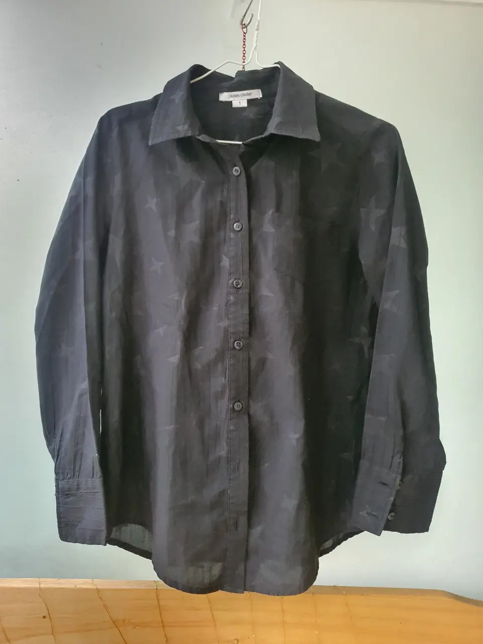 Camisa negra con estampado de estrellas, de la marca Jazmin Chebar. Talle 1. Ideal para un look casual o de salida.