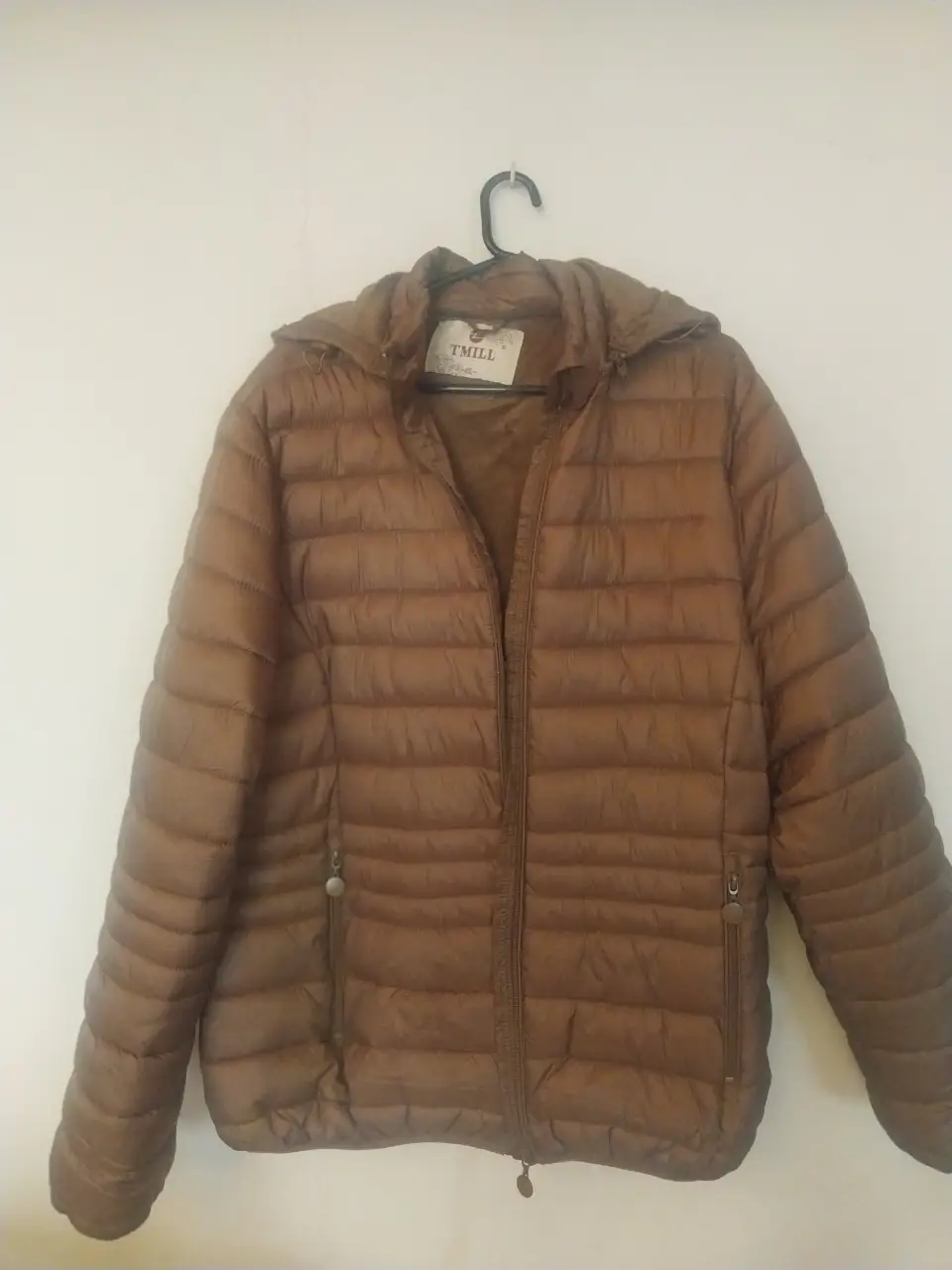 Campera de pluma marrón con piel sintética por dentro, ideal para el invierno. Con capucha y cierre frontal. Marca TMILL.