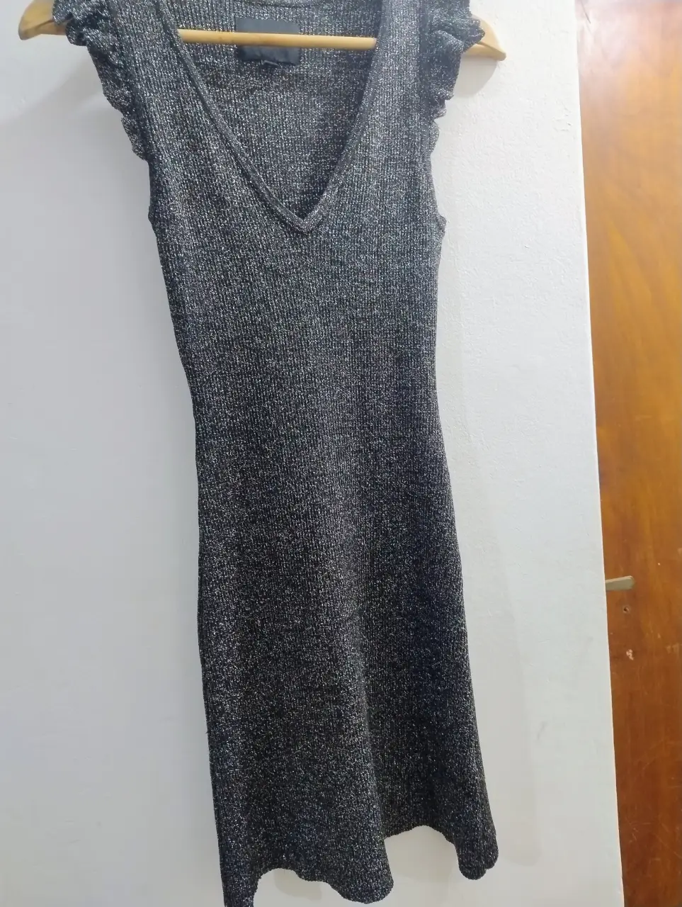 Vestido mini de fiesta con escote en V y volados en las mangas. Tejido brillante y elegante, ideal para eventos especiales.