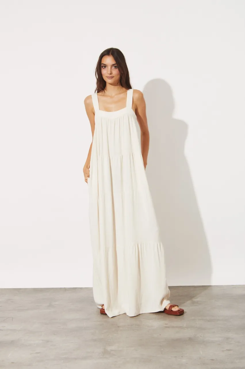 Vestido largo blanco, ideal para el verano. Con breteles anchos y falda con tajos, es perfecto para un look relajado y chic. Combinalo con sandalias para un outfit canchero.