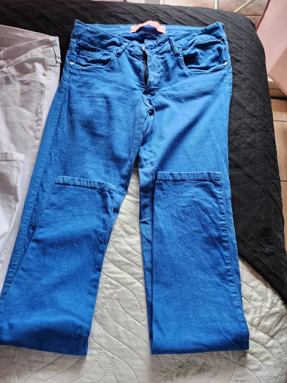 Jeans azules de corte clásico con cierre y botón. y blancos