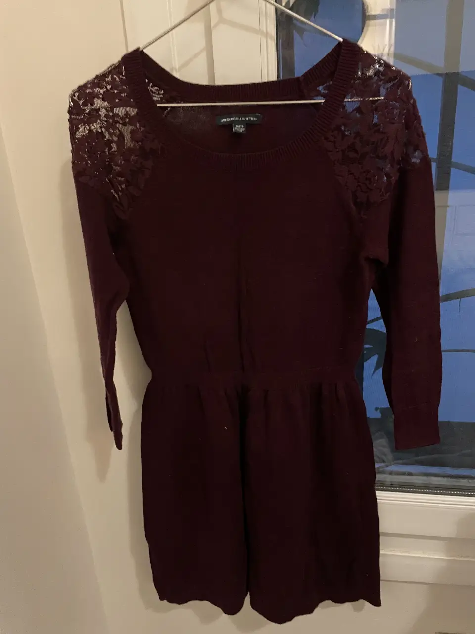 Vestido midi de American Eagle Outfitters en color borgoña, con mangas largas y detalles de encaje en los hombros. Ideal para una salida o evento especial. De lana
