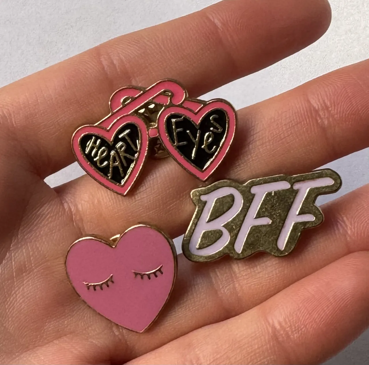 Set de 3 pines con diseños de corazón y la palabra BFF. Ideales para personalizar tu ropa o accesorios.