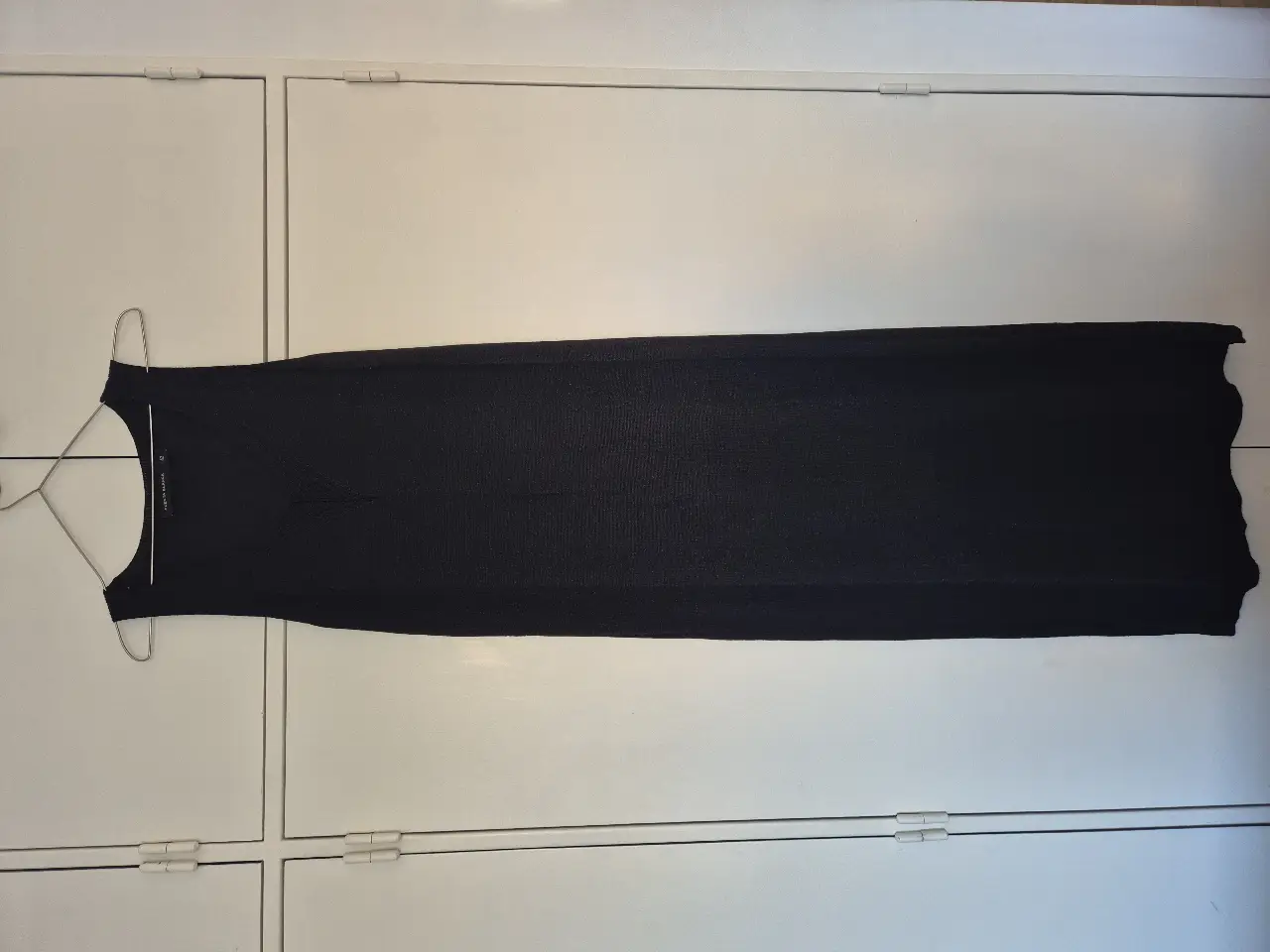 Vestido largo negro de Cuesta Blanca. Confeccionado en un tejido suave de hilo con lurex. Largo hasta arriba del tobillo. Pequeño tajo a los costados.