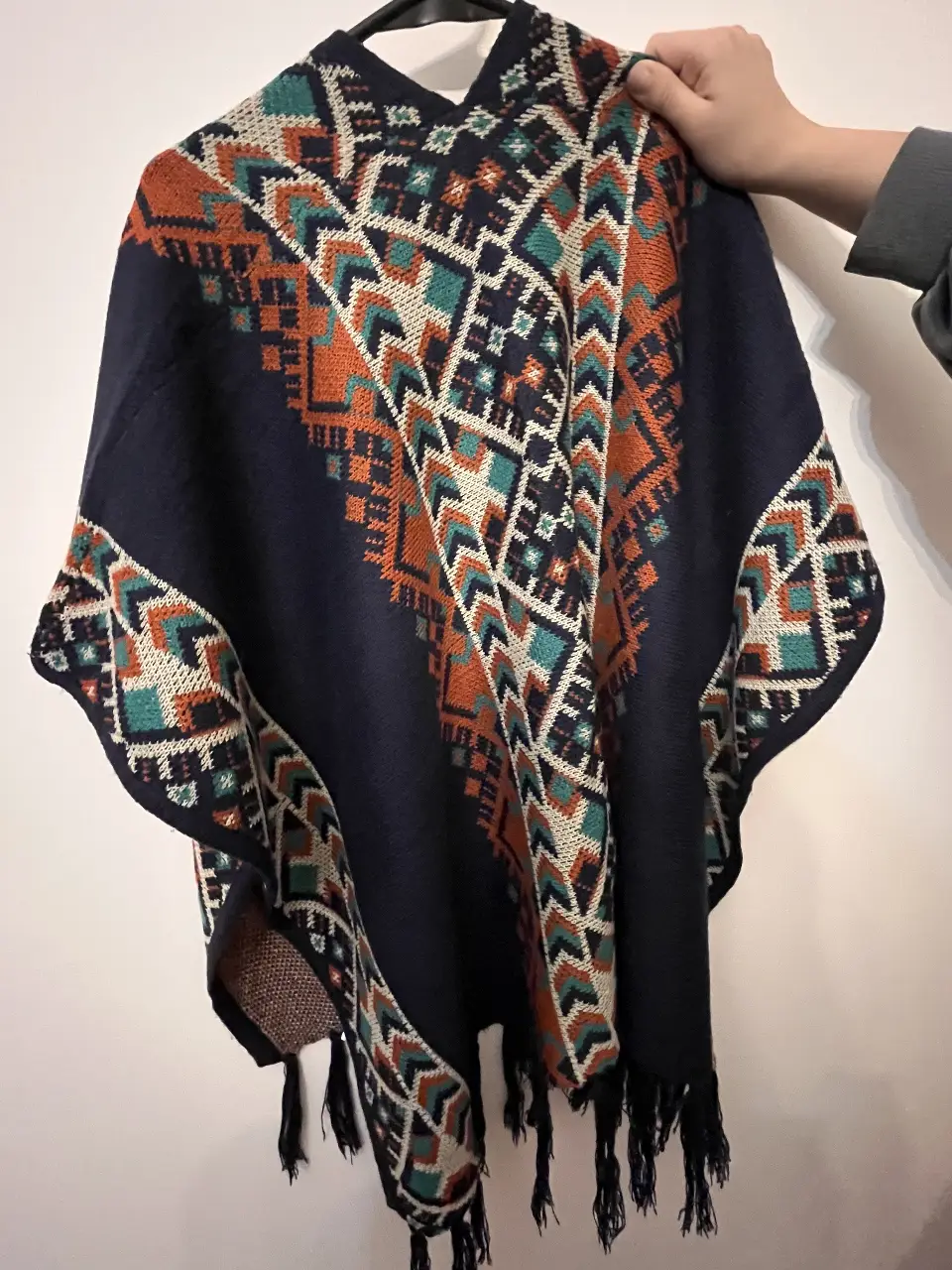 Poncho tejido con diseño étnico en tonos azul marino, naranja, verde y blanco. Ideal para un look bohemio  hippie chic y abrigado en otoño/invierno. 