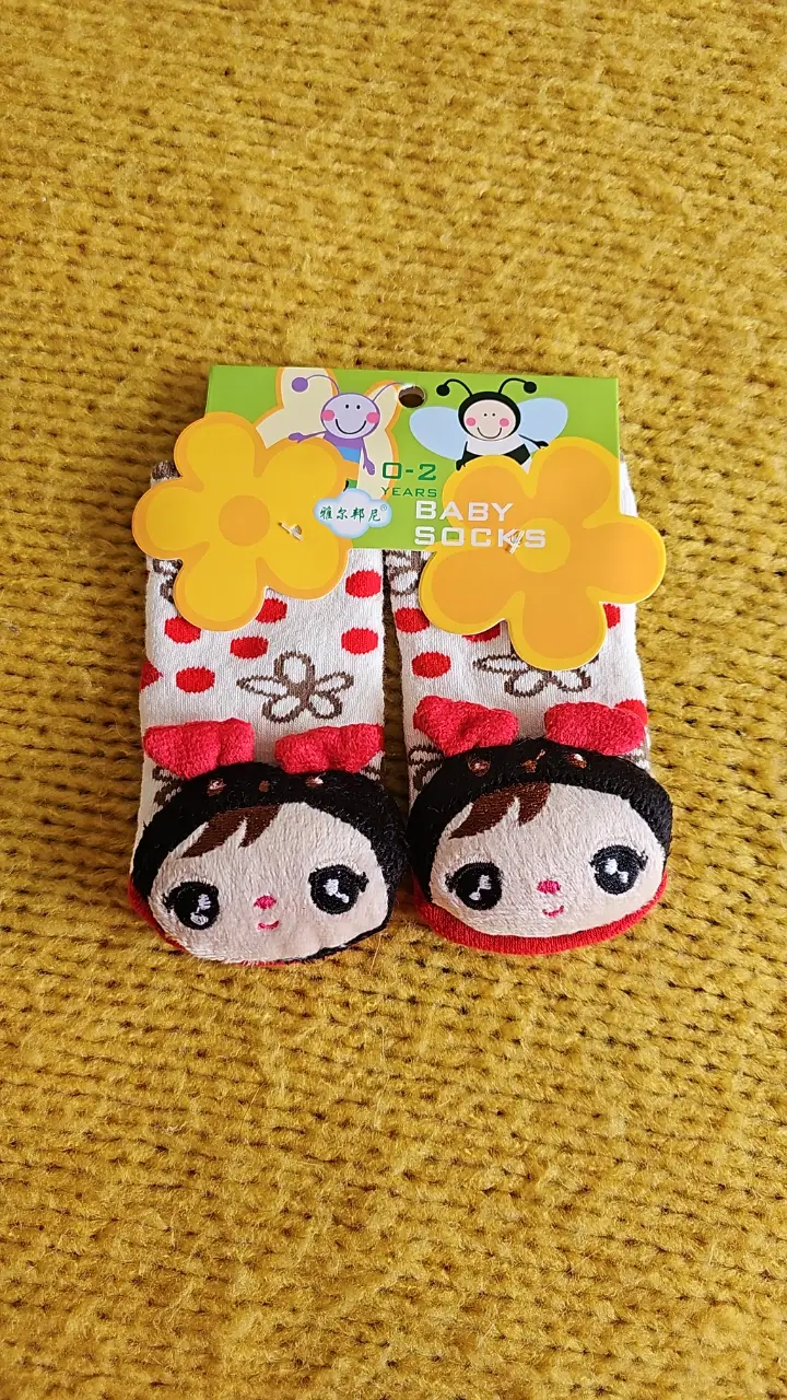 Lindos zoquetes para bebé con diseño de carita y flores. Ideales para mantener los pies de tu bebé abrigados y a la moda. para niños de 0 a 2 años, con muñequito en la puntera y un cascabel imterno