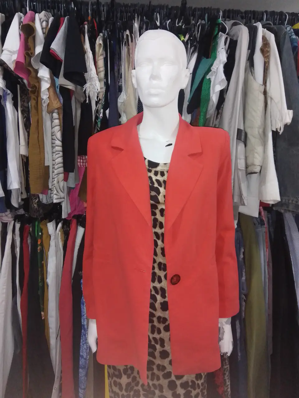 Blazer coral de mujer, con un solo botón y solapas clásicas, modelo largo. Ideal para un look elegante y sofisticado.