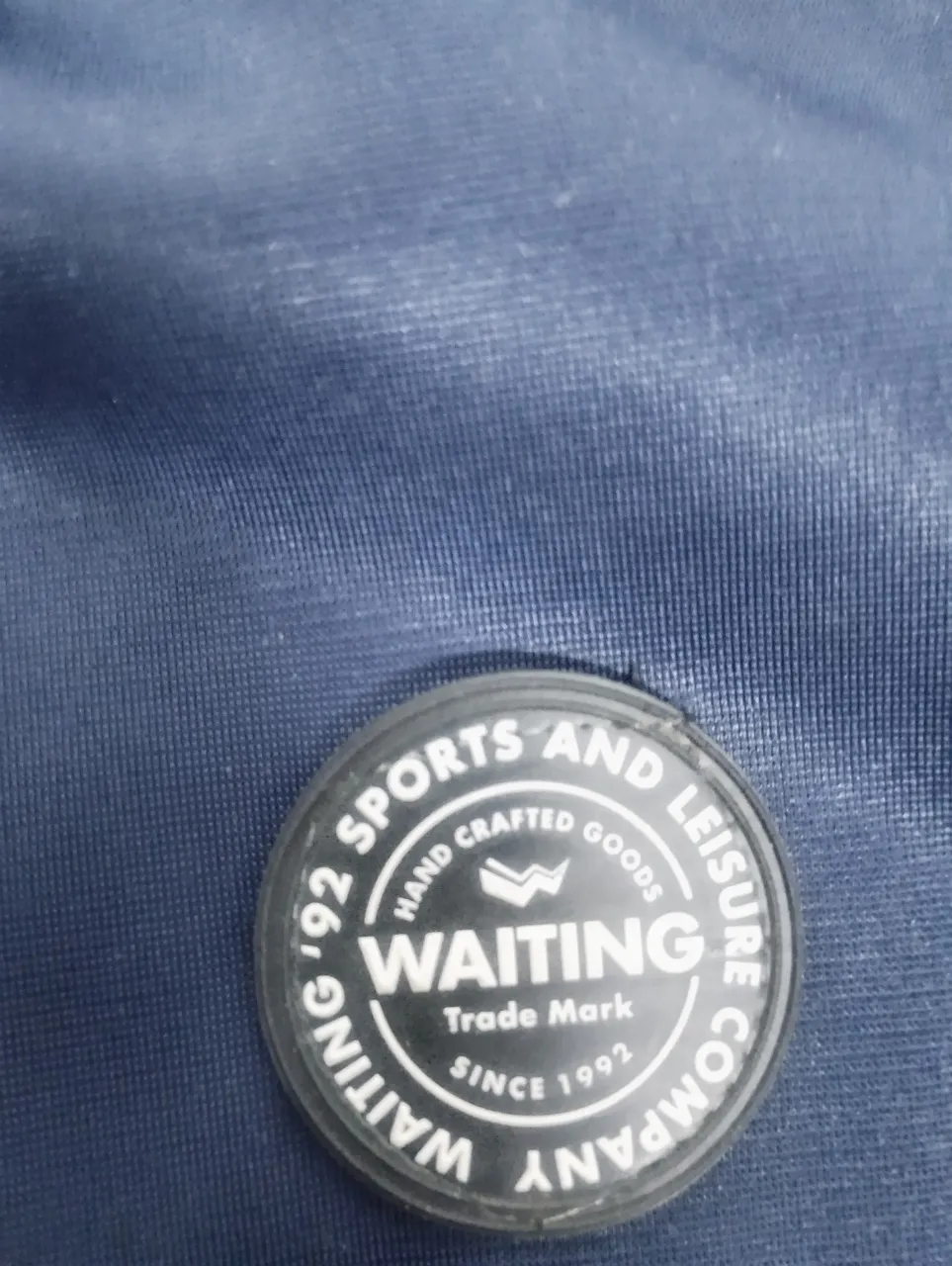 Buzo con cierre azul marino con detalles en blanco en las mangas. Posee capucha y un logo circular en el pecho. Ideal para un look deportivo y casual.