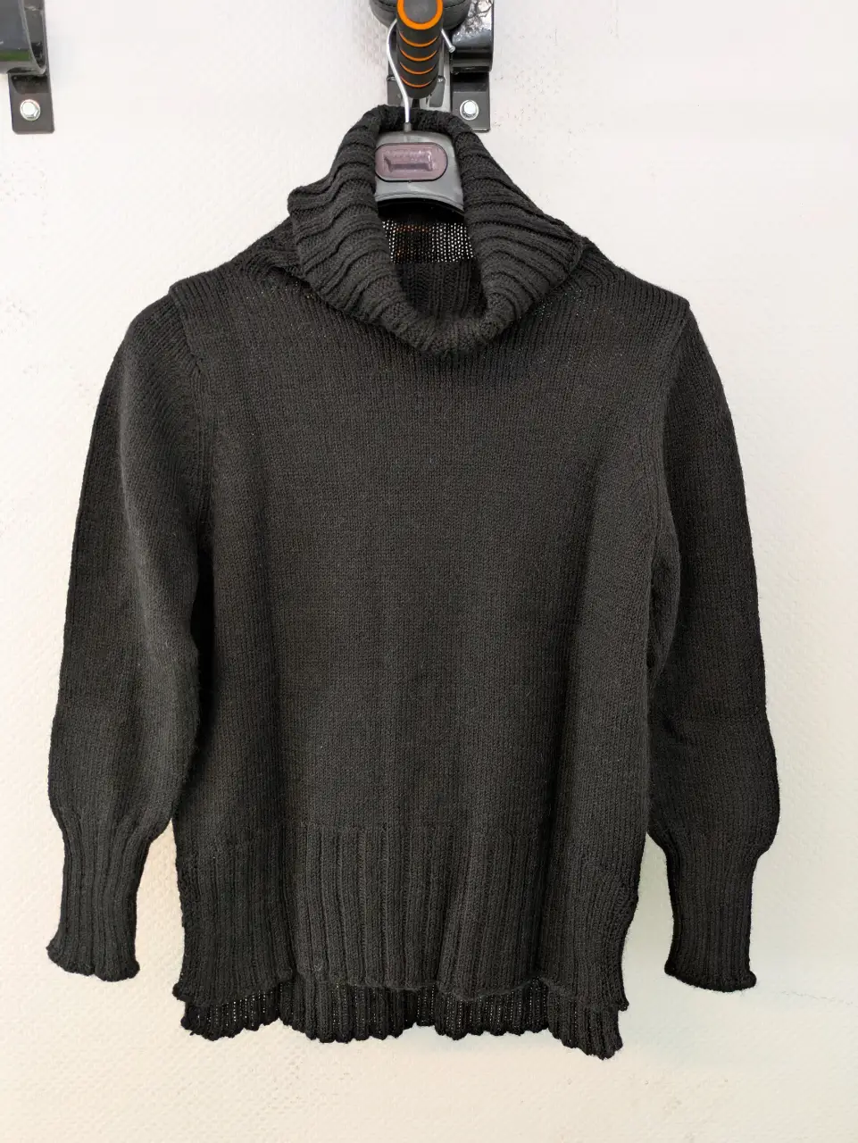 Clásico sweater de cuello alto en color negro, ideal para el invierno. Confeccionado en tejido de punto, este sweater ofrece un ajuste cómodo y abrigado. Perfecto para combinar con diferentes outfits.