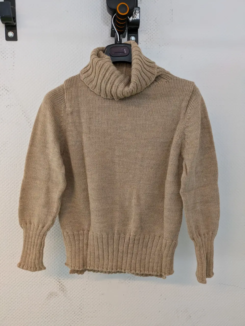 Sweater de cuello alto en color crudo, ideal para el invierno. Confeccionado en tejido de punto, este sweater ofrece un ajuste cómodo y un estilo clásico. Perfecto para combinar con jeans o pantalones de vestir.