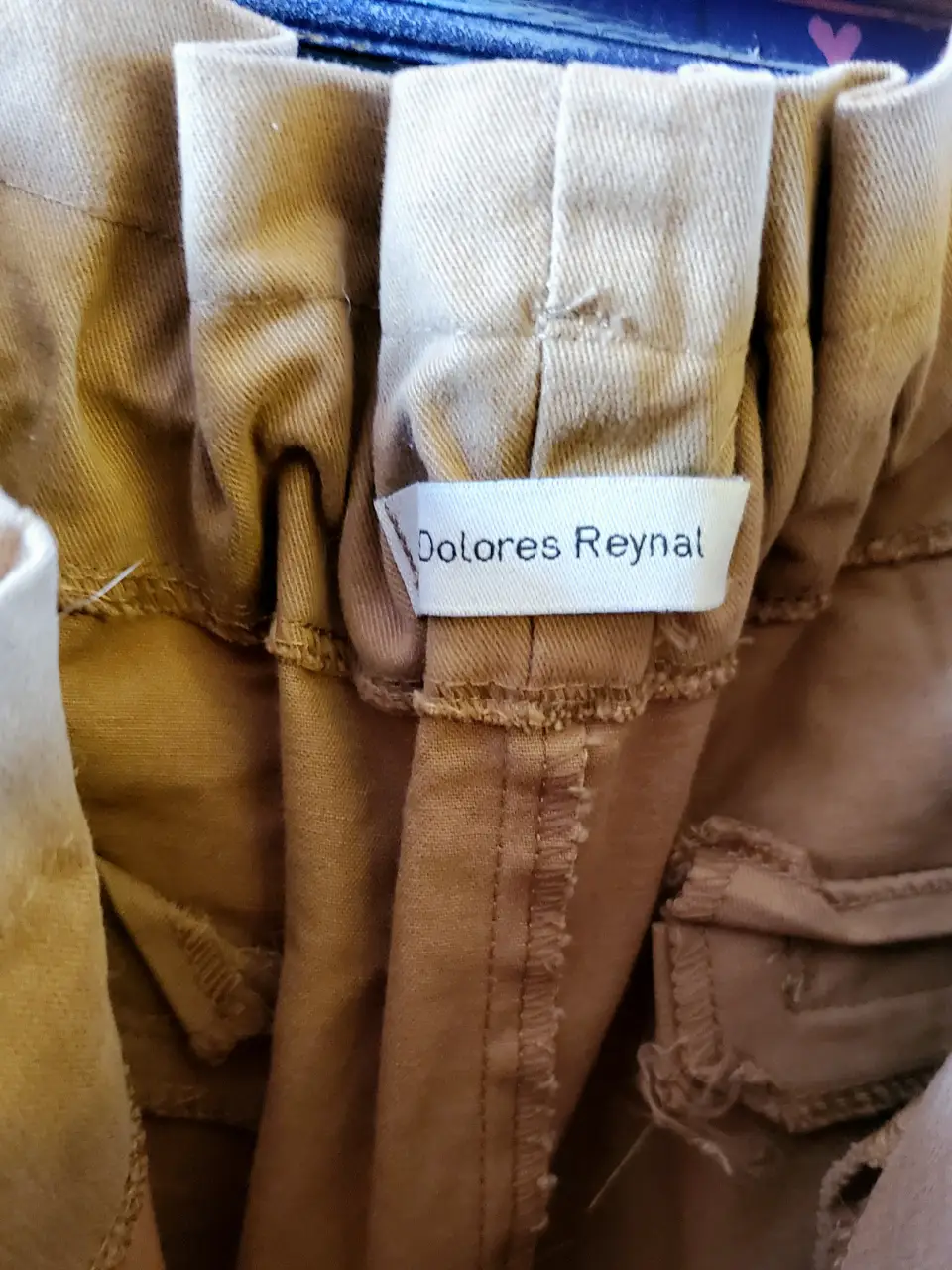 Pantalón chino de mujer, color khaki, con cintura elastizada y detalle de pinzas. Marca Dolores Reynal.