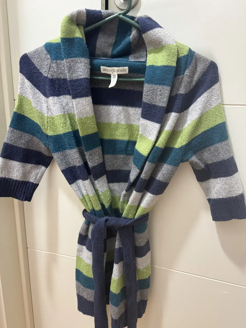 Cardigan de mujer Aeropostale a rayas en tonos grises, verdes y azul marino. Con cinturón para ajustar la cintura. Ideal para un look casual y abrigado.