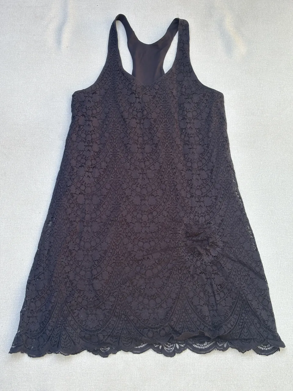 Vestido negro de encaje con breteles finos y escote redondo. Ideal para una salida o fiesta.

Detalle: tenía una colita atada y le quedó la forma, del círculo atado, se ve en la foto