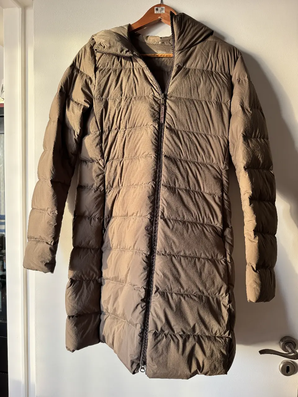 Campera larga de pluma color marrón, con capucha y cierre. Ideal para el invierno. PARECE NUEVA. Repele el agua, relleno de plumas. 