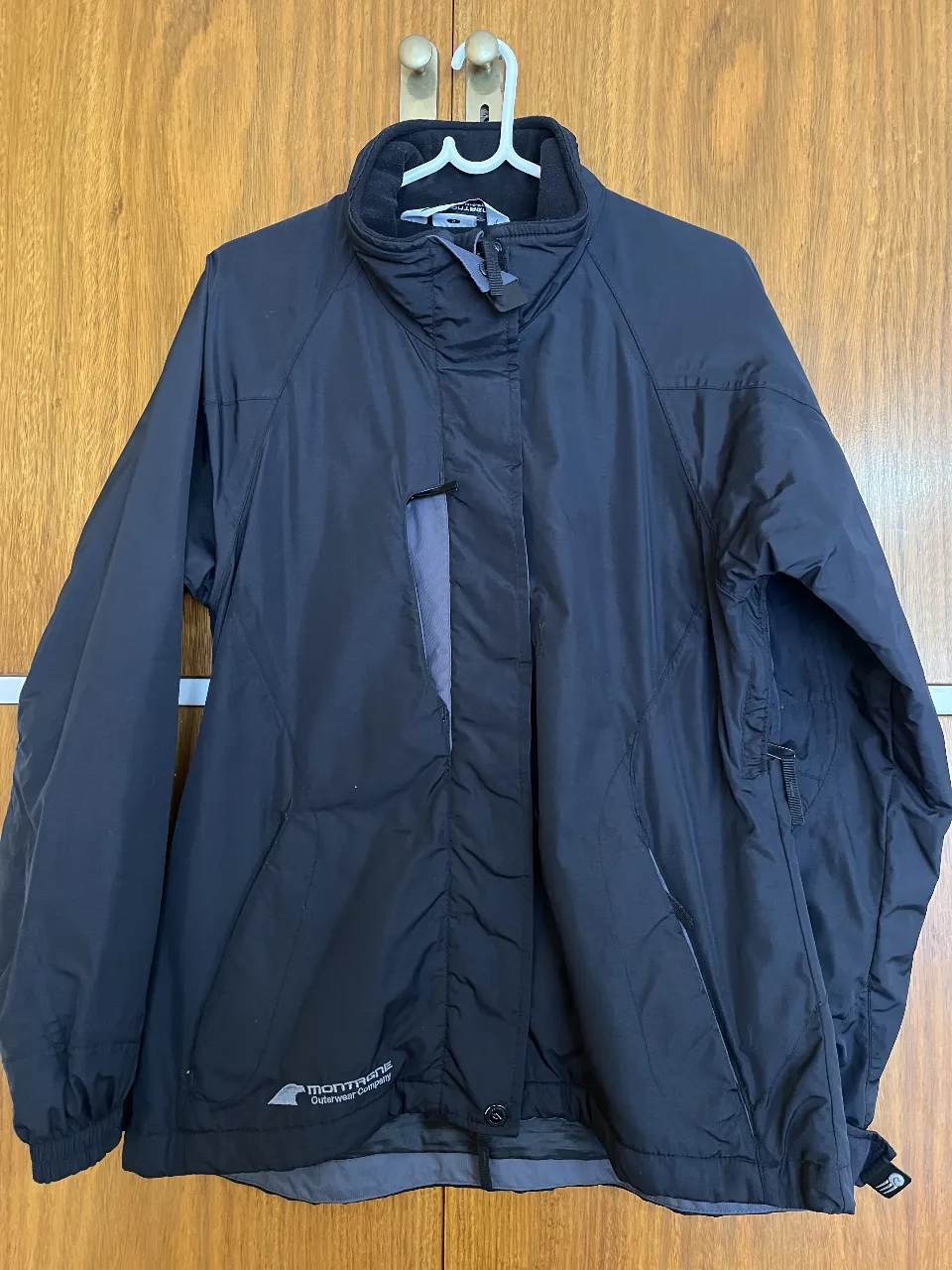 Campera Montagne de abrigo para mujer, color negro, con bolsillos, capucha desmontable y cierre. Tiene un cinturón interno para evitar el ingreso de nieve. Ideal para actividades al aire libre. Talle M/2.