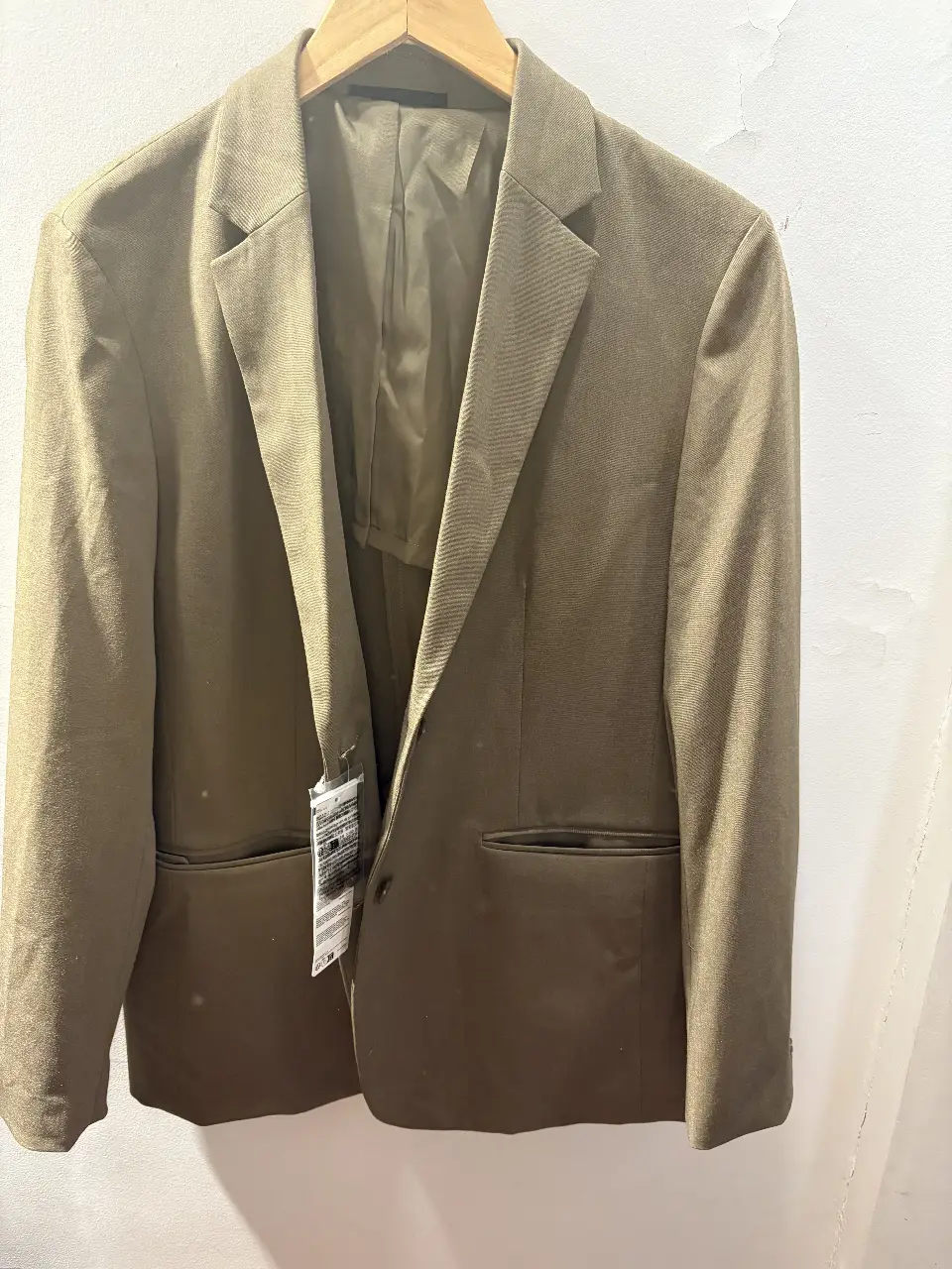 Blazer de mujer color verde oliva, con etiqueta. Ideal para un look formal o casual.