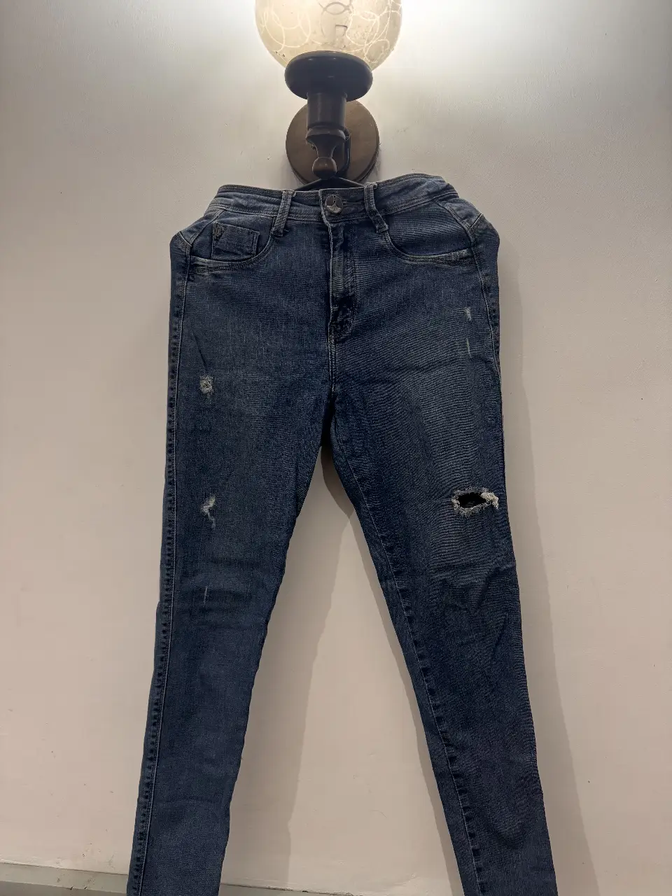 Jeans de mujer, azul, con roturas y detalles desgastados. Tiro medio, corte skinny. Ideal para un look casual y moderno.