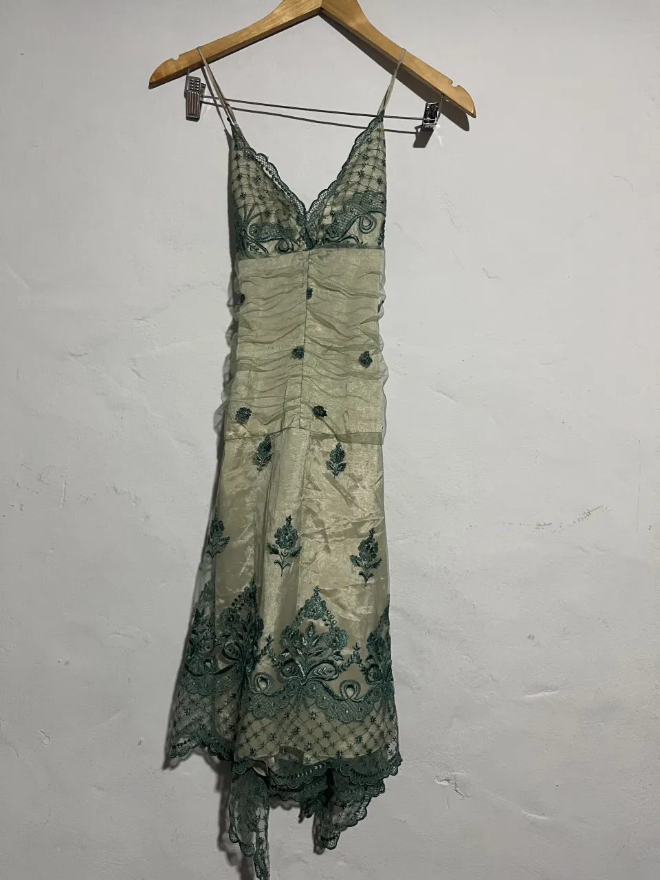 Vestido largo de fiesta, con delicados bordados florales en tono verde esmeralda sobre una base de seda color crudo. Posee un diseño drapeado en la cintura y tiras finas. Ideal para eventos formales o casamientos.(DETALLE EN LA ULTIMA FOTO)