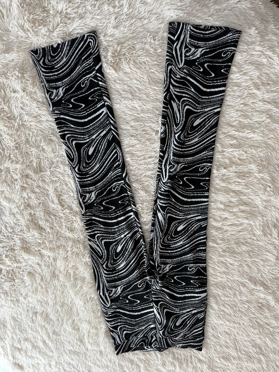 Pantalón de vestir con estampado abstracto en blanco y negro. De la marca Zara, talle S/26. Ideal para un look moderno y sofisticado.