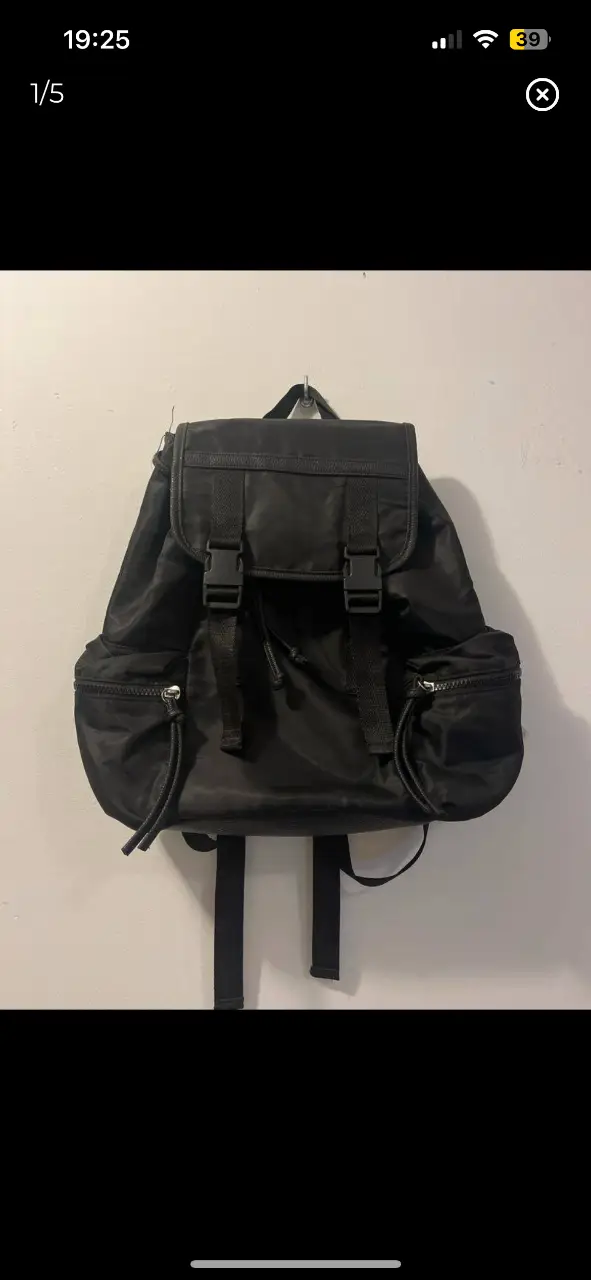 Mochila negra con solapa y cierre de hebillas. Cuenta con bolsillos laterales con cierre y correas ajustables. Ideal para uso diario. medidas: 31cm de alto x 35 de ancho x 14cm de profundidad. 