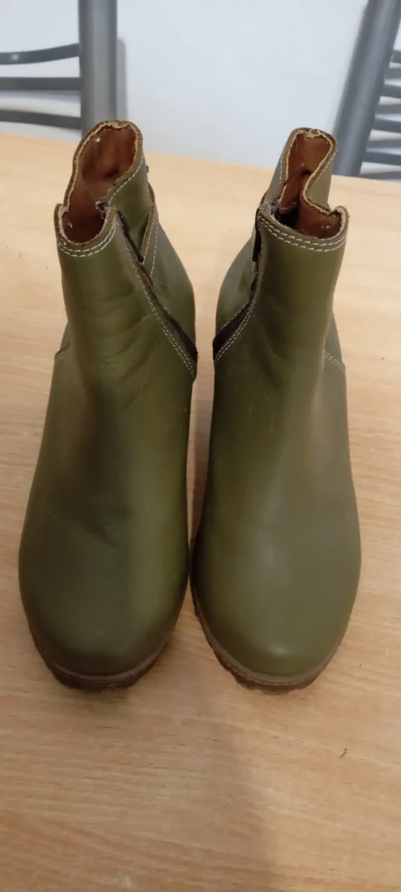 Botitas de cuero color verde militar, con cierre lateral y detalle de hebilla. Ideales para un look casual y canchero. Sin detalles de uso.