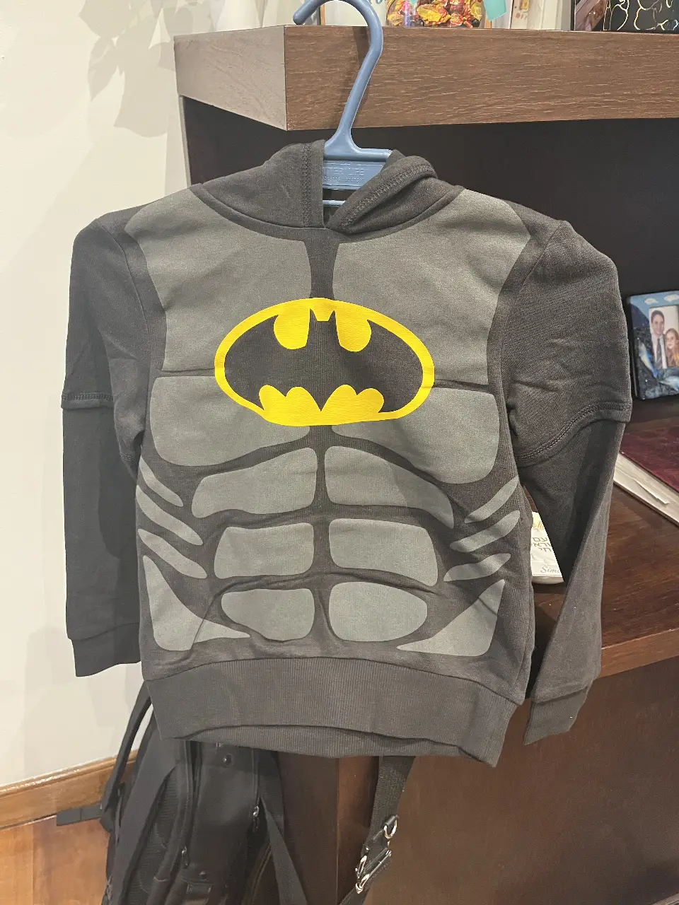Buzo con capucha para niño, diseño de Batman con el logo en amarillo. Ideal para un look casual y cómodo.