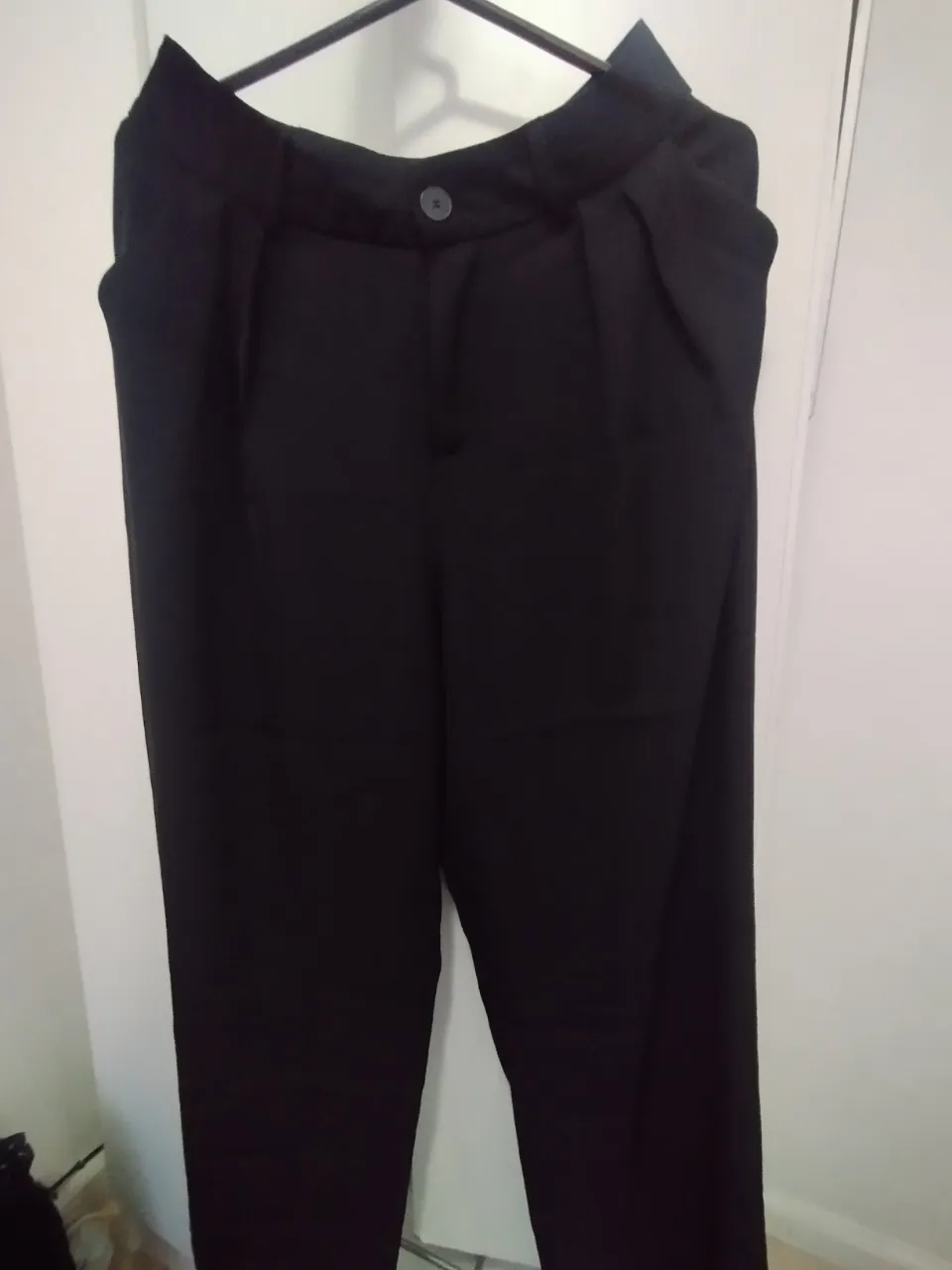 Pantalón sastrero negro, de corte recto y tiro alto. Ideal para un look elegante y sofisticado.