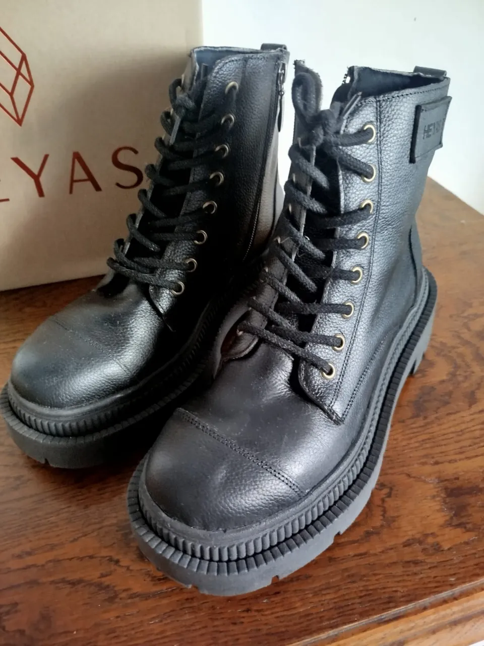 Botas de cuero negras con cordones y cierre lateral. Suela gruesa y acordonada. Un uso.
